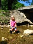 Amanda sitting in the creek